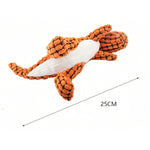An orange textured dog toy shaped like a fish or shark, shown on a white background with a black measurement line and text indicating 25CM length.